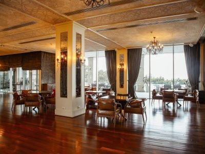 restaurant hall with leather armchairs and french windows